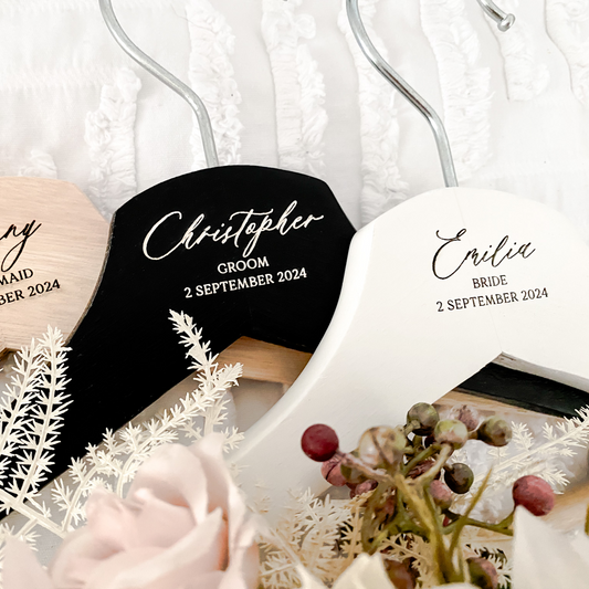 Custom engraved wooden coat hanger designed as a personalised wedding gift and keepsake. Ideal for brides, bridesmaids, and grooms, this hanger adds a thoughtful detail to wedding photography and preparation. Perfect for wedding favours or personalised gifts, each hanger is made with care, featuring premium quality wood and elegant engraving for a timeless look to complement any special occasion.