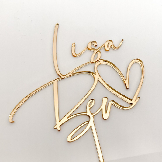 Romantic gold acrylic heart wedding cake topper, personalised to suit your wedding or engagement. Elegant and modern design adds charm and style to any cake, available in multiple colours for customisation. Durable yet lightweight acrylic ensures easy placement, making it perfect for weddings, anniversaries, or love-themed celebrations. Handmade in Australia, this topper is both décor and keepsake
