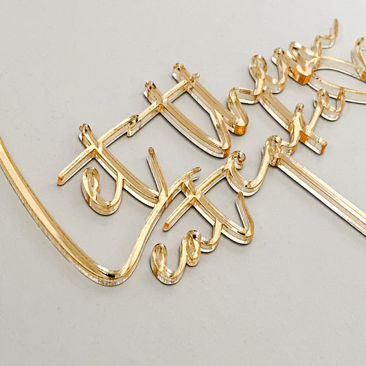 Custom gold acrylic “Let Them Eat Cake” cake topper featuring chic modern lettering. Ideal for weddings, engagement parties, birthdays, and bridal showers. Crafted from premium quality acrylic, this topper is both stylish and durable, available in multiple colours to suit any theme. Perfect for brides and grooms, event planners, or hosts looking for personalised cake decorations. Handmade in Australia, this topper creates a memorable and elegant cake display