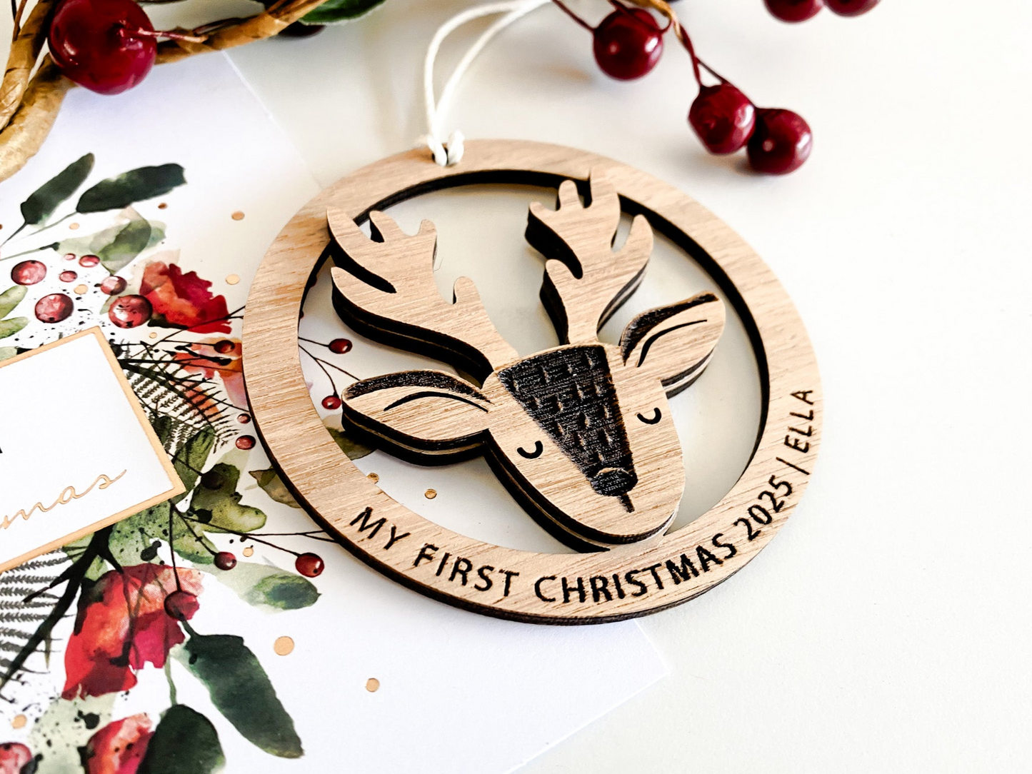 Handcrafted wooden reindeer ornament that doubles as a custom Christmas bauble or tree ornament, perfect for celebrating My First Christmas. This eco-friendly Christmas ornament features a delicate reindeer design within a round frame, ideal for use as a Christmas tag, Christmas name keepsake, or personalised gift. A timeless gift for Christmas to decorate your Christmas tree with warmth and charm, available in four beautiful colour options.
