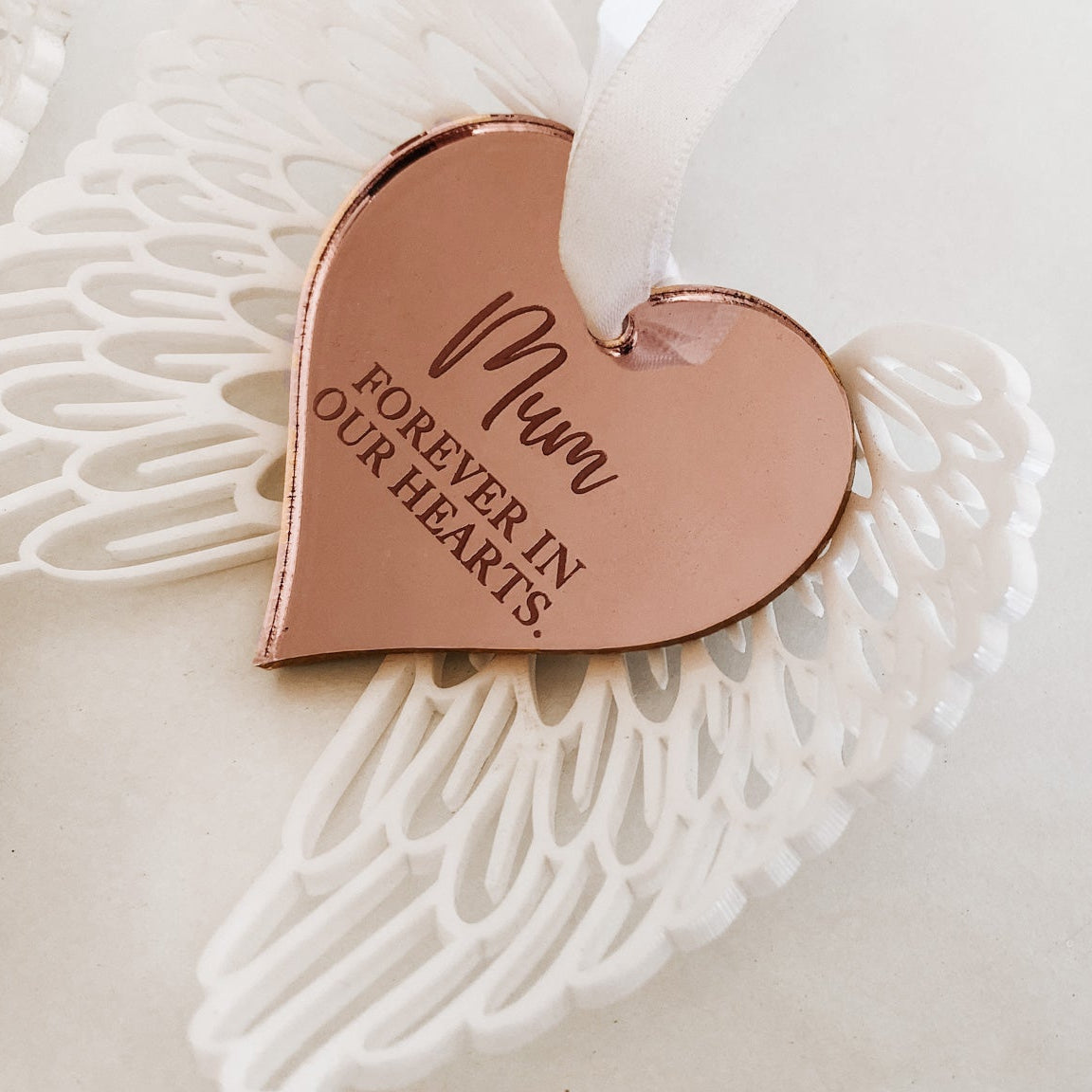 White angel wings with rose gold heart centre. Hanging ornament complete with white sating ribbon. Perfect sympathy or remembrance gift.