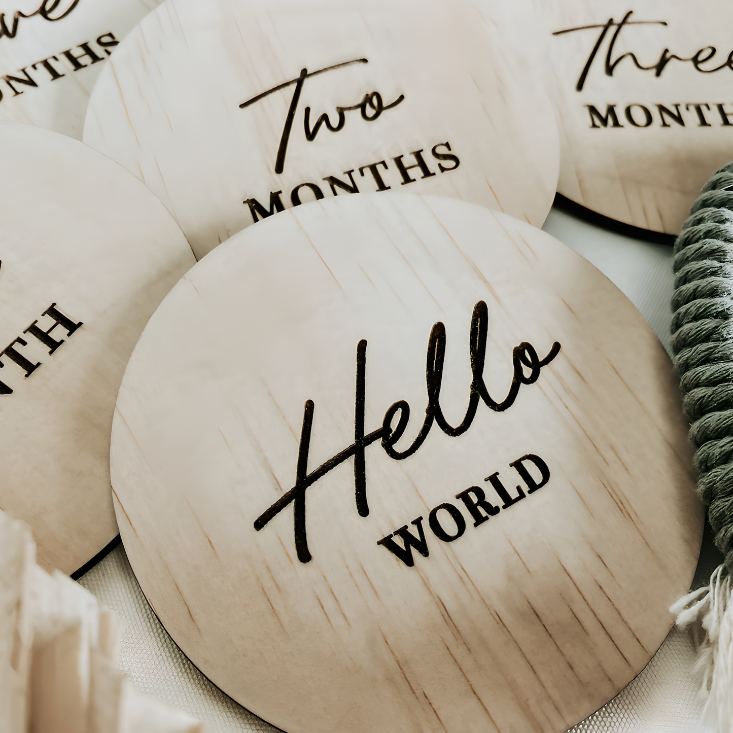 Boho style nursery arrangement featuring wooden milestone markers and natural textures.