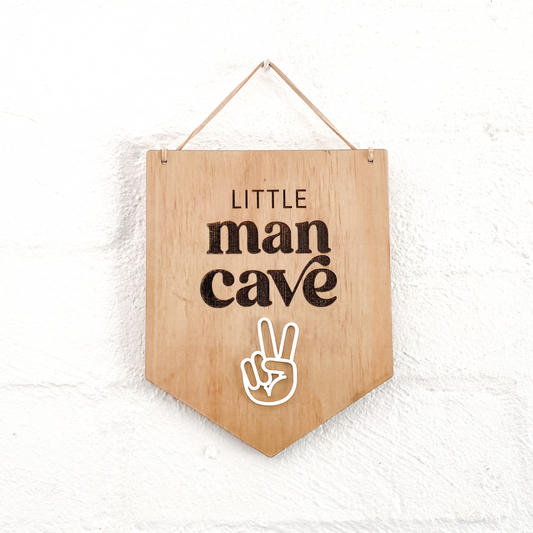 Close-up of the boys nursery wall sign showing the 3D layered white acrylic peace sign detail.