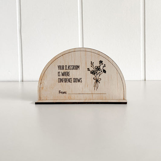 Close-up of a laser-engraved wooden plaque for teachers, celebrating confidence in the classroom.