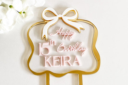 3D layered acrylic birthday cake topper with bow design