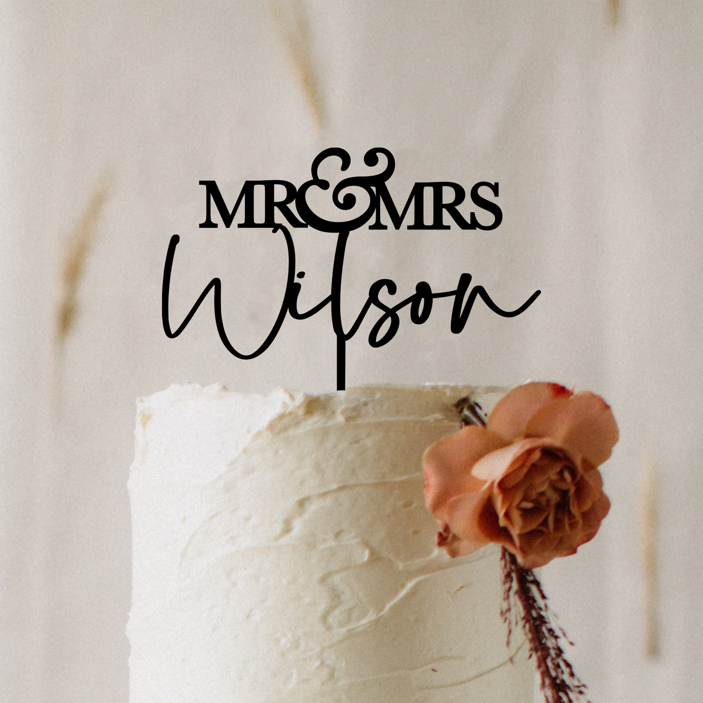 Elegant custom “Mr & Mrs” wedding cake topper made-to-order in Australia, crafted from premium acrylic for a timeless and modern look. Shown displayed on a wedding cake surrounded by soft floral décor in neutral tones, this personalised topper is available in three sizes and multiple colour options to suit any theme. A keepsake decoration designed to add romance, style, and sophistication to weddings, engagements, anniversaries, or special celebrations.