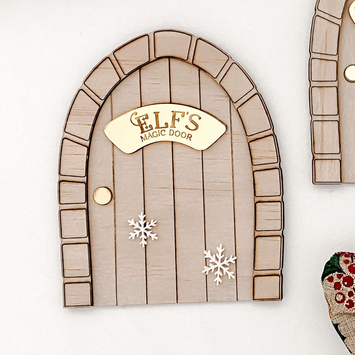 Personalised children’s Elf Door crafted from natural wood and layered acrylic. Features engraved gold plaque, festive snowflakes, and rustic texture — a timeless Christmas keepsake to inspire festive storytelling.