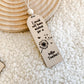 Teacher Appreciation Gift, Top-down view of an arch-shaped wooden bookmark engraved with a dandelion and teacher quote.