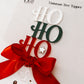 Handcrafted Acrylic Ho Ho Ho Tree Topper by Bell & Beau Design Co – a premium holiday decoration made from layered acrylic in Christmas colours, adorned with a luxurious red bow and silver star. Perfect for modern home Christmas décor or gift-giving.