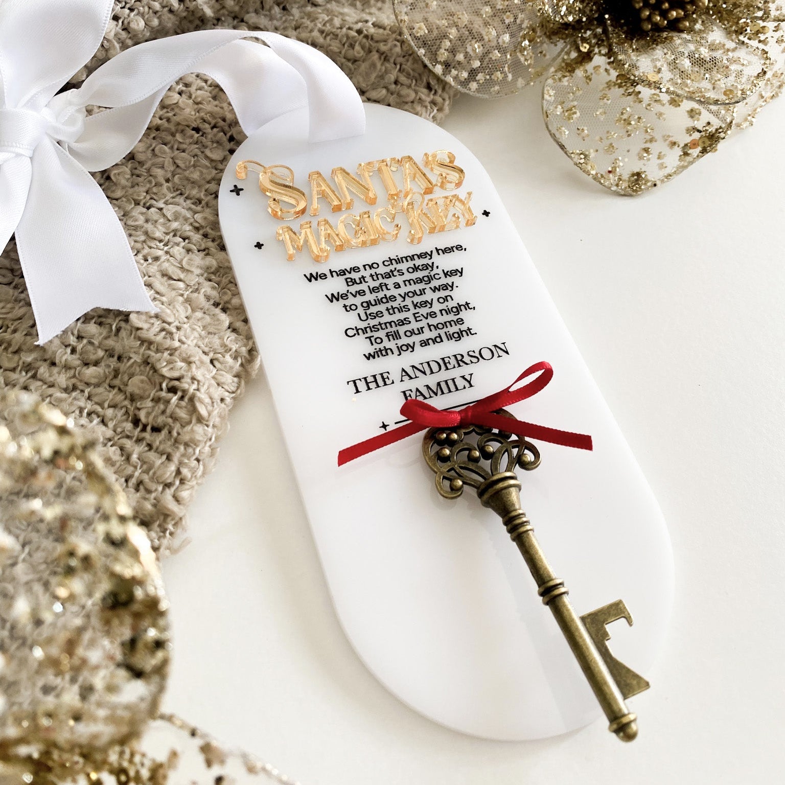 ersonalised Santa’s Magic Key tag featuring 3D gold lettering, engraved poem, and vintage brass key tied with a red ribbon. Crafted from premium white acrylic and finished with a white satin bow, this festive keepsake is perfect for homes without a chimney and adds a magical touch to your family’s Christmas Eve tradition.