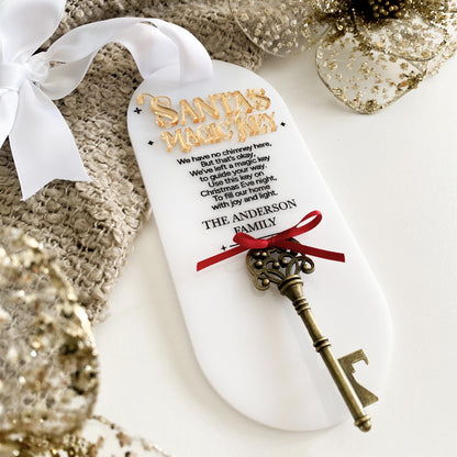 ersonalised Santa’s Magic Key tag featuring 3D gold lettering, engraved poem, and vintage brass key tied with a red ribbon. Crafted from premium white acrylic and finished with a white satin bow, this festive keepsake is perfect for homes without a chimney and adds a magical touch to your family’s Christmas Eve tradition.