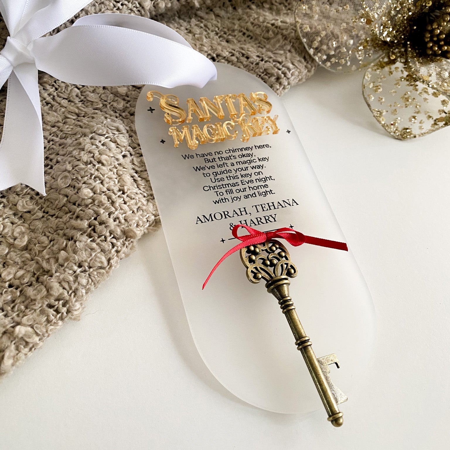 Beautiful handcrafted Santa’s Magic Key tag made from 3mm acrylic with 3D gold text and custom family name. Includes an antique brass key tied with a delicate red bow and white satin ribbon for hanging — a cherished Christmas tradition for children and families.