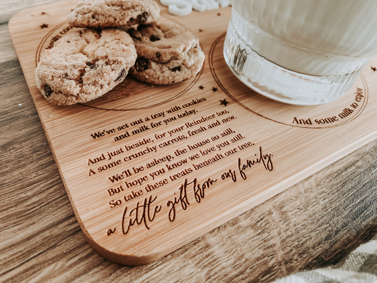 Close-up of custom engraving area reading “A little gift from our family”. Personalised Christmas Eve Santa board crafted from bamboo, perfect sentimental gift for kids or parents to use each year. Eco-friendly and beautifully crafted.