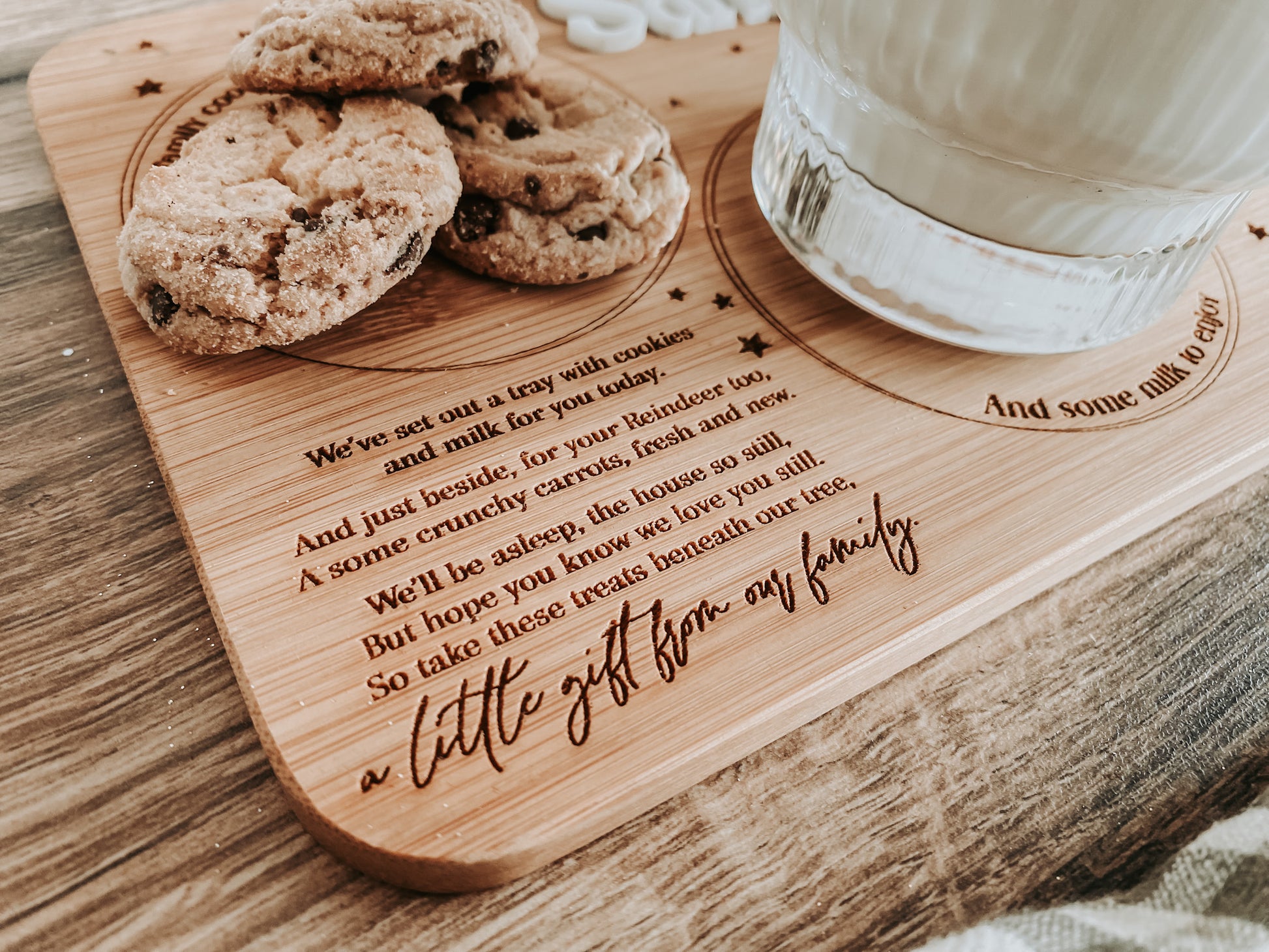 Close-up of custom engraving area reading “A little gift from our family”. Personalised Christmas Eve Santa board crafted from bamboo, perfect sentimental gift for kids or parents to use each year. Eco-friendly and beautifully crafted.