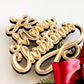 Rustic wooden and acrylic Merry Christmas Star Tree Topper with gold 3D lettering, featuring festive greenery and a red satin bow. This family tree topper makes a beautiful Christmas decoration and Christmas keepsake, perfect for a rustic Christmas or white star topper theme. A unique Xmas tree topper alternative designed to create lasting family memories and traditions year after year.