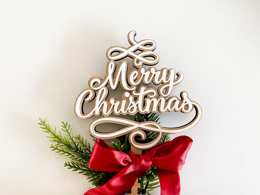 Beautiful Merry Christmas star design made from layered wood and acrylic in white, styled with pine foliage and a red satin ribbon. This Christmas tree topper doubles as a heartfelt Christmas keepsake and family tradition piece, adding rustic elegance to your Christmas decor. A unique Xmas star topper alternative created by Bell & Beau Design Co.