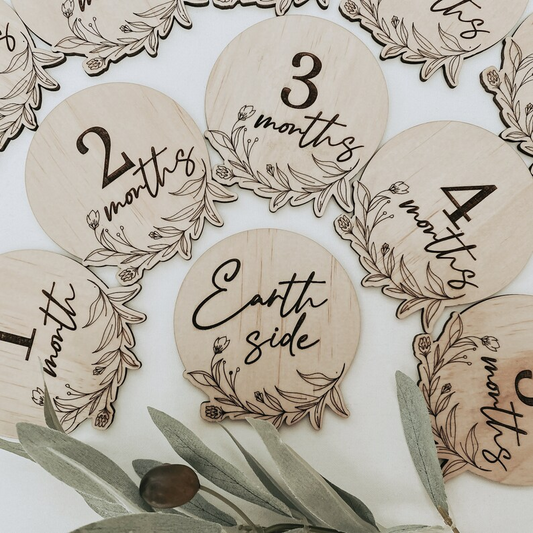 Newborn floral milestone disc set featuring 13 engraved wooden baby monthly markers. Includes “Hello World” through “One Year” for capturing your baby’s first milestones in photography sessions. Delicate floral artwork engraved on FSC-certified wood, handmade in Australia. Perfect as a baby shower gift, photo prop, or keepsake for parents cherishing their little one’s first year.