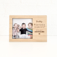 Wooden photo frame with a family photo and engraved message on a white background