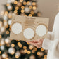 woman holding an engraved Santa treat tray surrounded by a Christmas Eve setup.