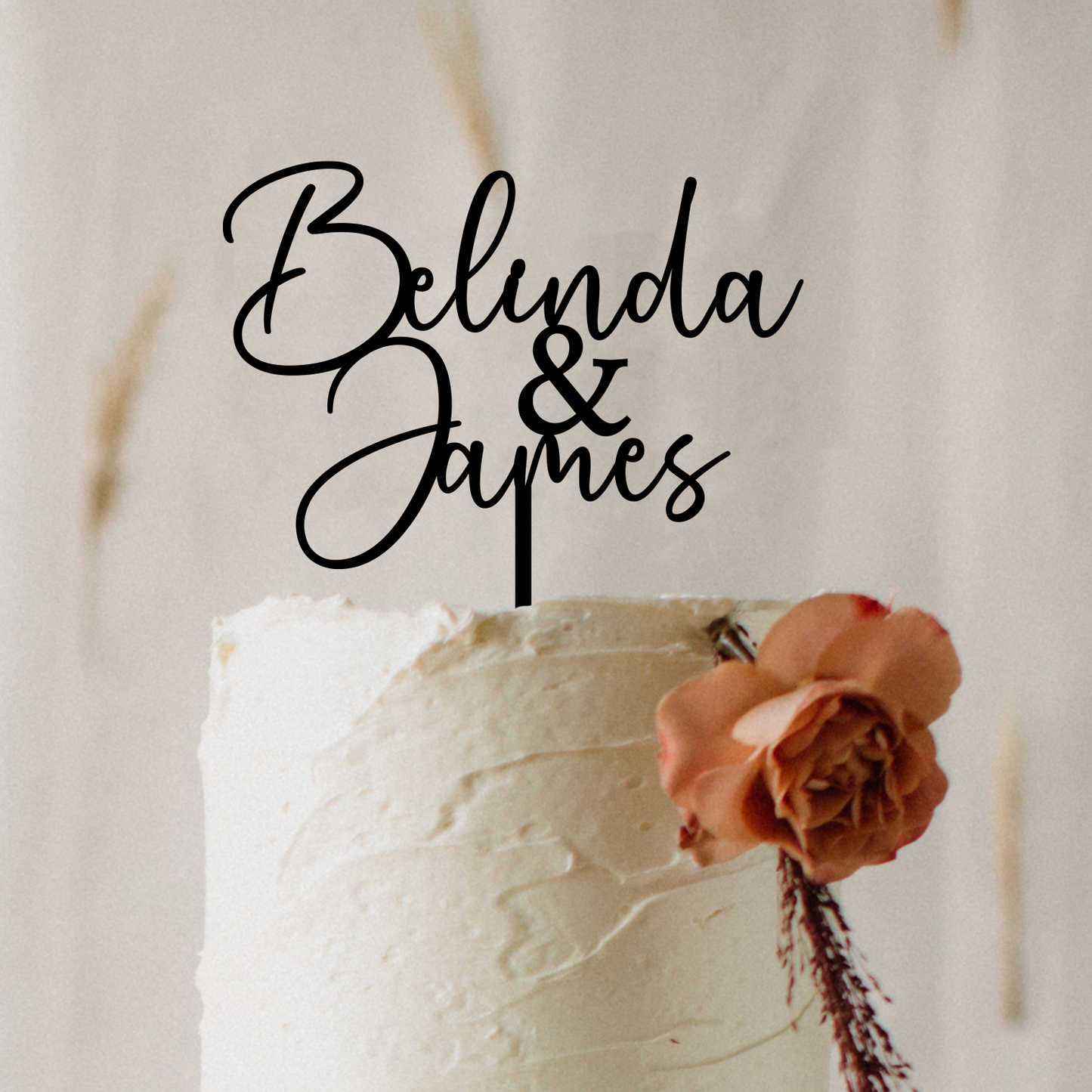 Personalised acrylic wedding cake topper in modern script font featuring custom names. Elegant, laser-cut cake decoration designed to suit weddings, engagements, anniversaries, and special events. Lightweight yet durable acrylic makes it the perfect keepsake. Stylish black lettering enhances your cake display, ideal for couples seeking custom wedding décor and unique personalised details.
