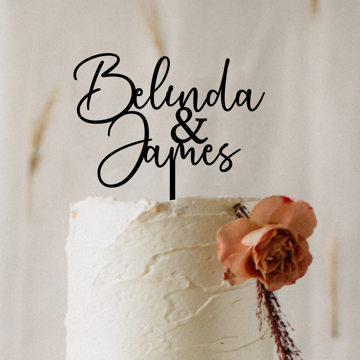 Personalised acrylic wedding cake topper in modern script font featuring custom names. Elegant, laser-cut cake decoration designed to suit weddings, engagements, anniversaries, and special events. Lightweight yet durable acrylic makes it the perfect keepsake. Stylish black lettering enhances your cake display, ideal for couples seeking custom wedding décor and unique personalised details.