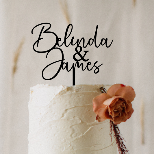 Personalised acrylic wedding cake topper in modern script font featuring custom names. Elegant, laser-cut cake decoration designed to suit weddings, engagements, anniversaries, and special events. Lightweight yet durable acrylic makes it the perfect keepsake. Stylish black lettering enhances your cake display, ideal for couples seeking custom wedding décor and unique personalised details.