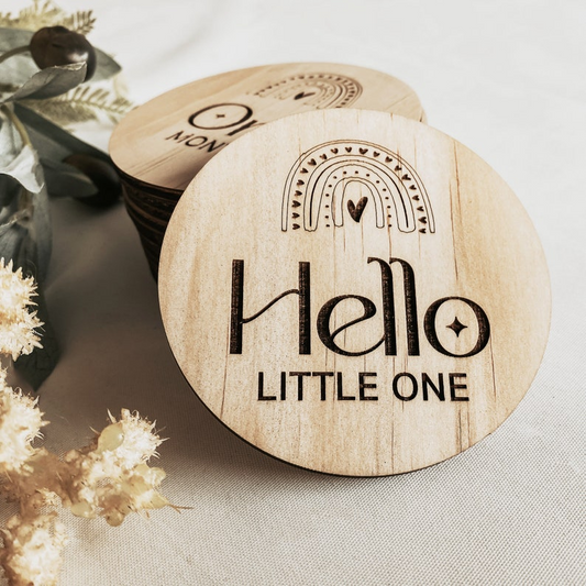 Rainbow wooden baby milestone discs engraved with “Hello Little One” through to “One Year,” perfect for newborn photos, monthly milestone shoots, and first birthday memories. Each 8cm disc is crafted from FSC-certified wood, with a delicate rainbow motif. Ideal as a baby shower gift, keepsake, or nursery photo prop, these monthly markers help parents capture and treasure their baby’s first year with love.