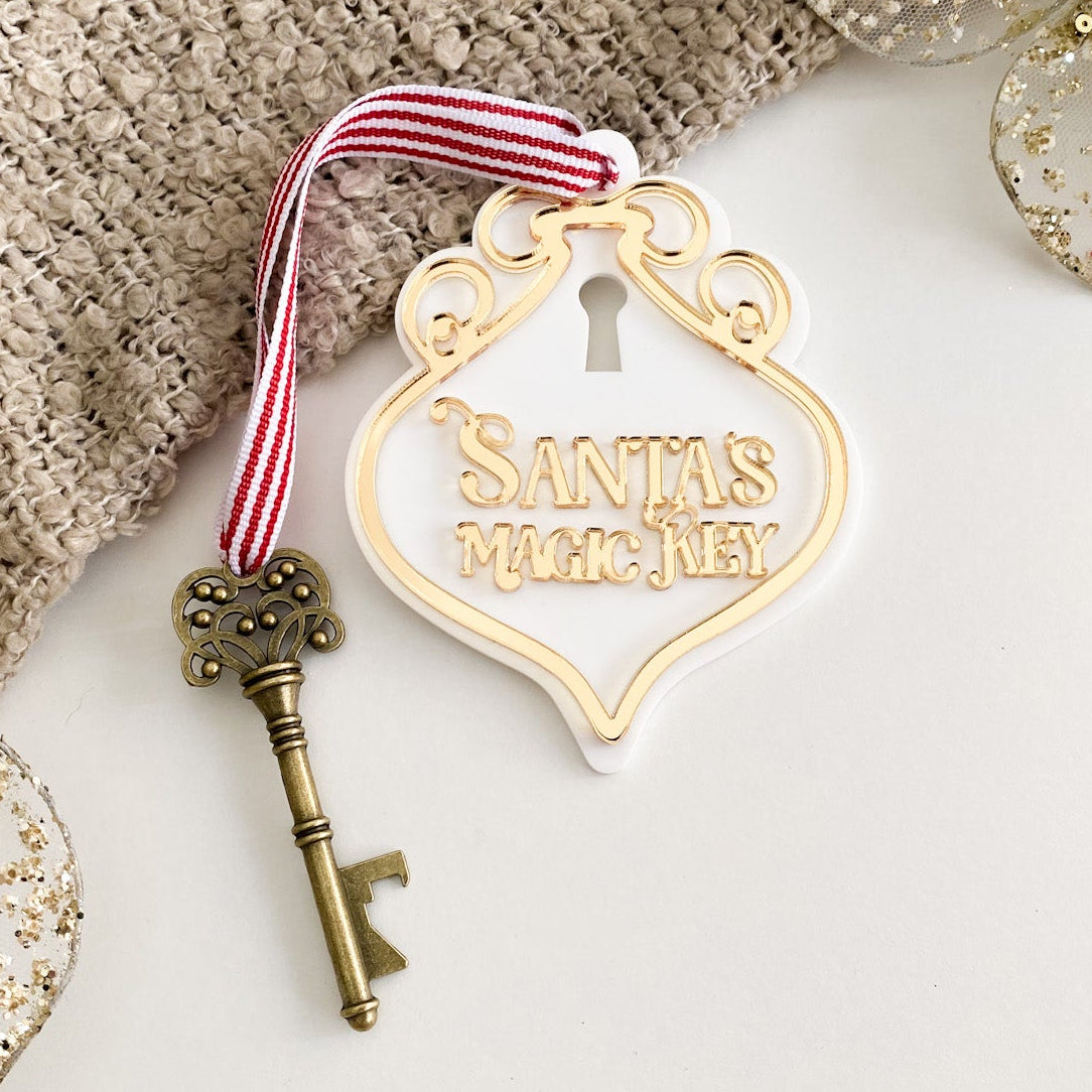 Gold mirrored acrylic Santa’s Magic Key sign with ornate detailing, vintage key, and festive red striped ribbon – perfect no-chimney Christmas solution.