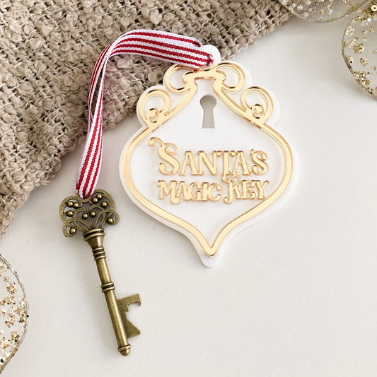 Gold mirrored acrylic Santa’s Magic Key sign with ornate detailing, vintage key, and festive red striped ribbon – perfect no-chimney Christmas solution.