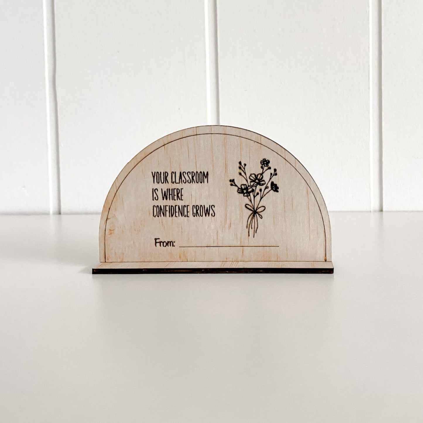 Close-up of a laser-engraved wooden plaque for teachers, celebrating confidence in the classroom.