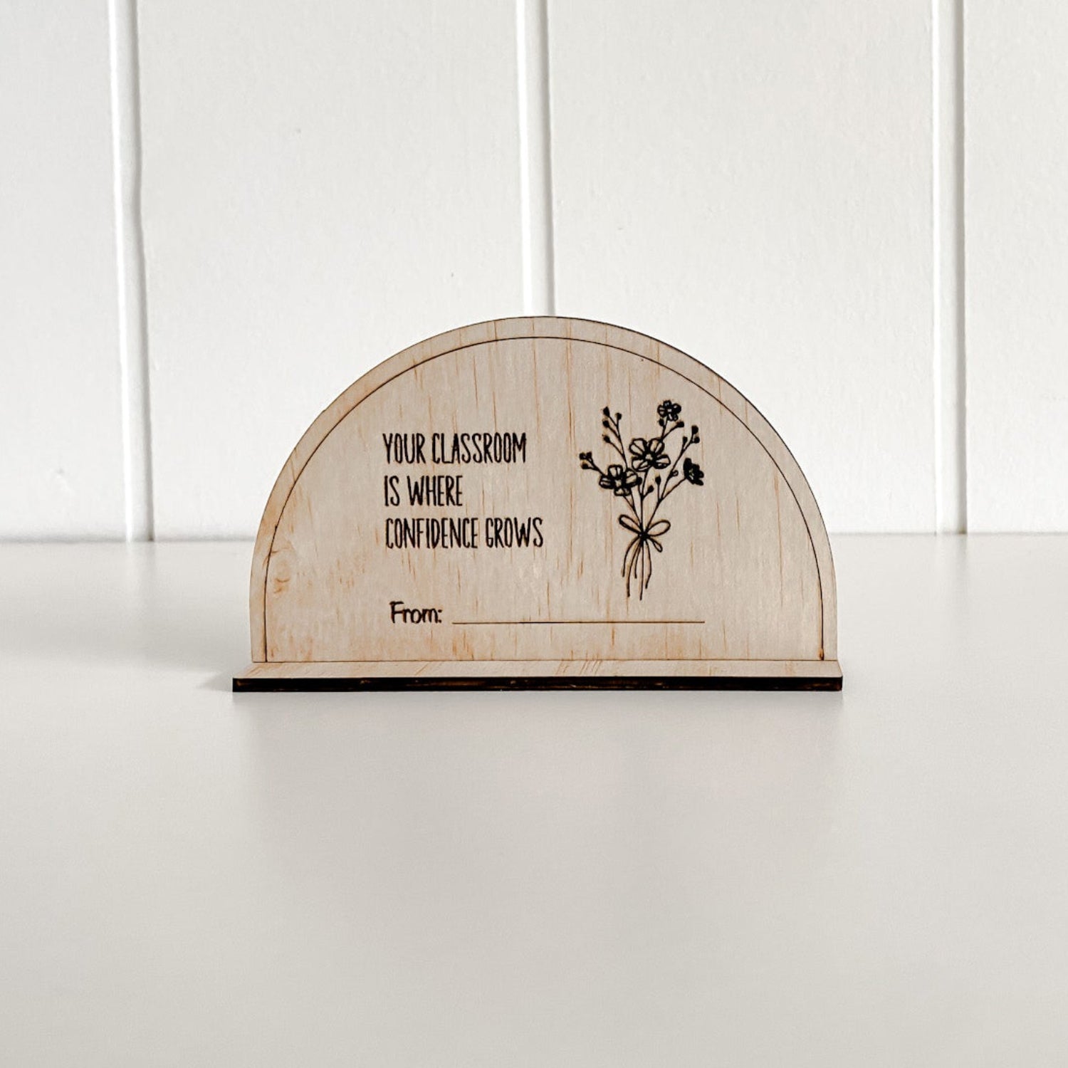 Close-up of a laser-engraved wooden plaque for teachers, celebrating confidence in the classroom.