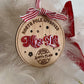 A side-view detail showing the layering of the natural wood and the glossy red acrylic on the Kids Nice List Ornamen