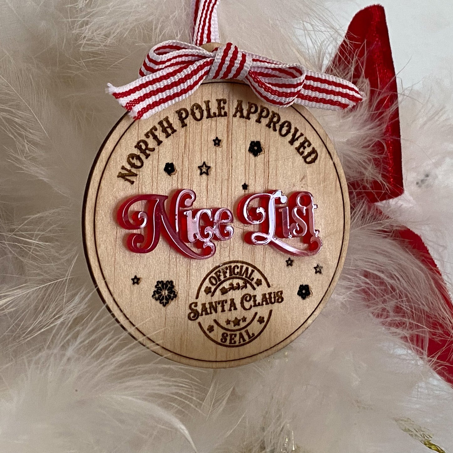 A side-view detail showing the layering of the natural wood and the glossy red acrylic on the Kids Nice List Ornamen