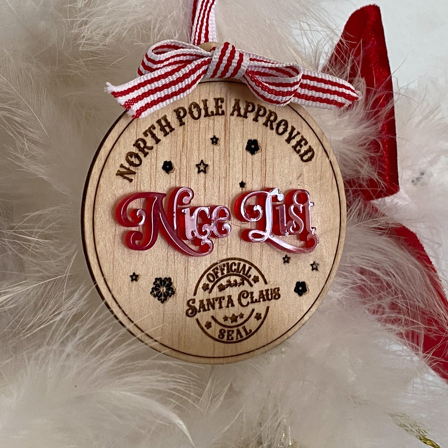 A side-view detail showing the layering of the natural wood and the glossy red acrylic on the Kids Nice List Ornamen