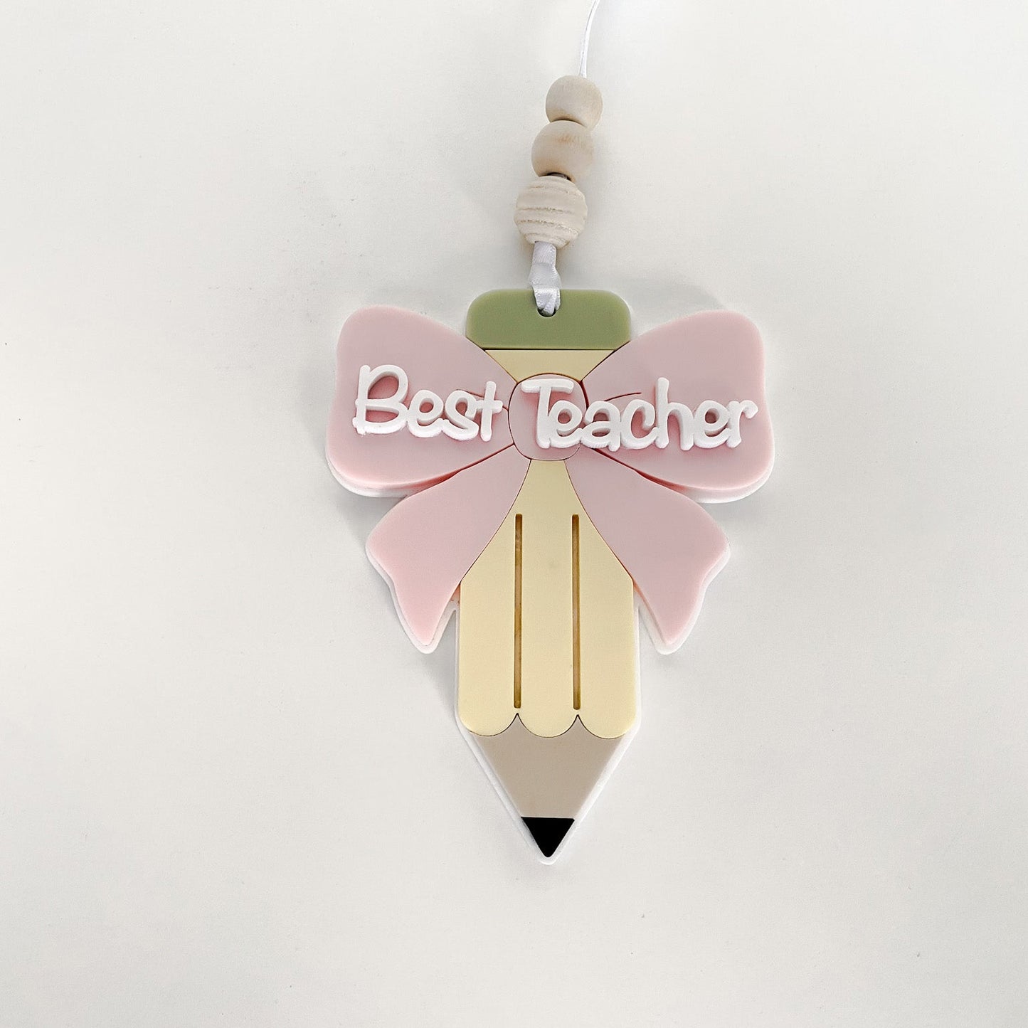 Single layered acrylic teacher appreciation ornament with a pink bow and the words Best Teacher