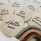 Close up of wooden Hello World disc for newborn birth announcement photos