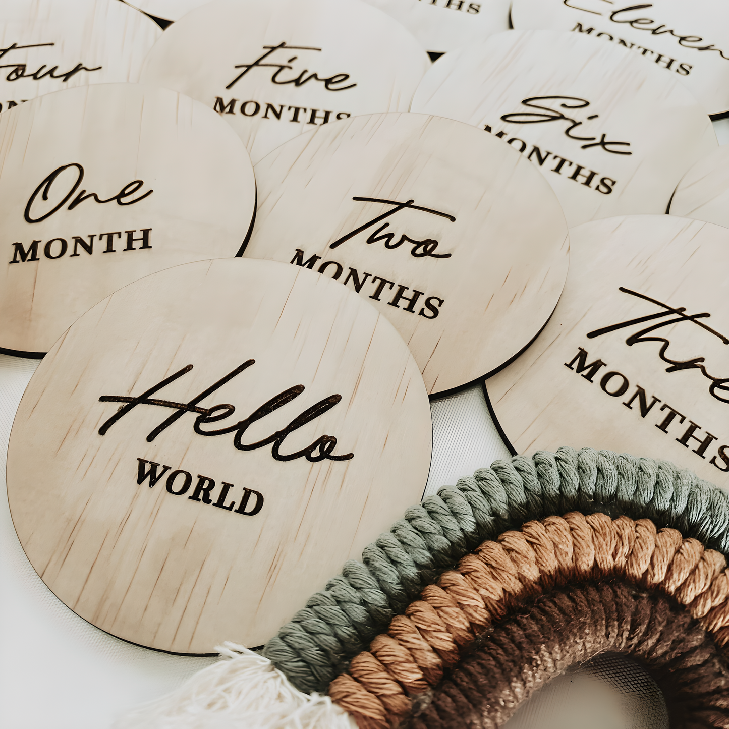 Close up of wooden Hello World disc for newborn birth announcement photos