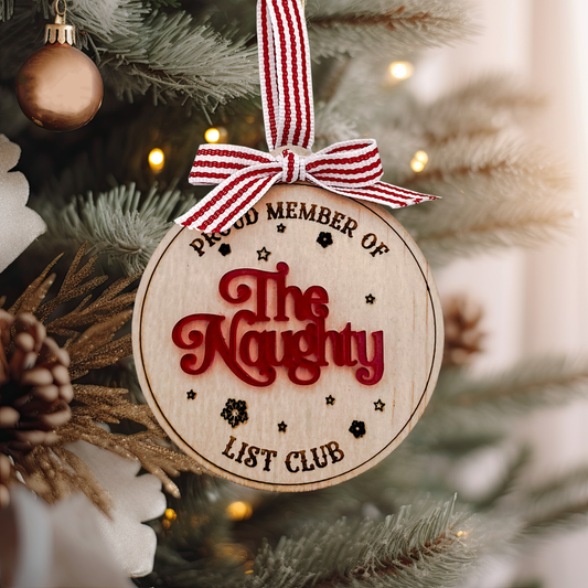 Detailed view of the laser-engraved wooden Naughty List Ornament featuring the "Proud Member Of The Naughty List Club" tex