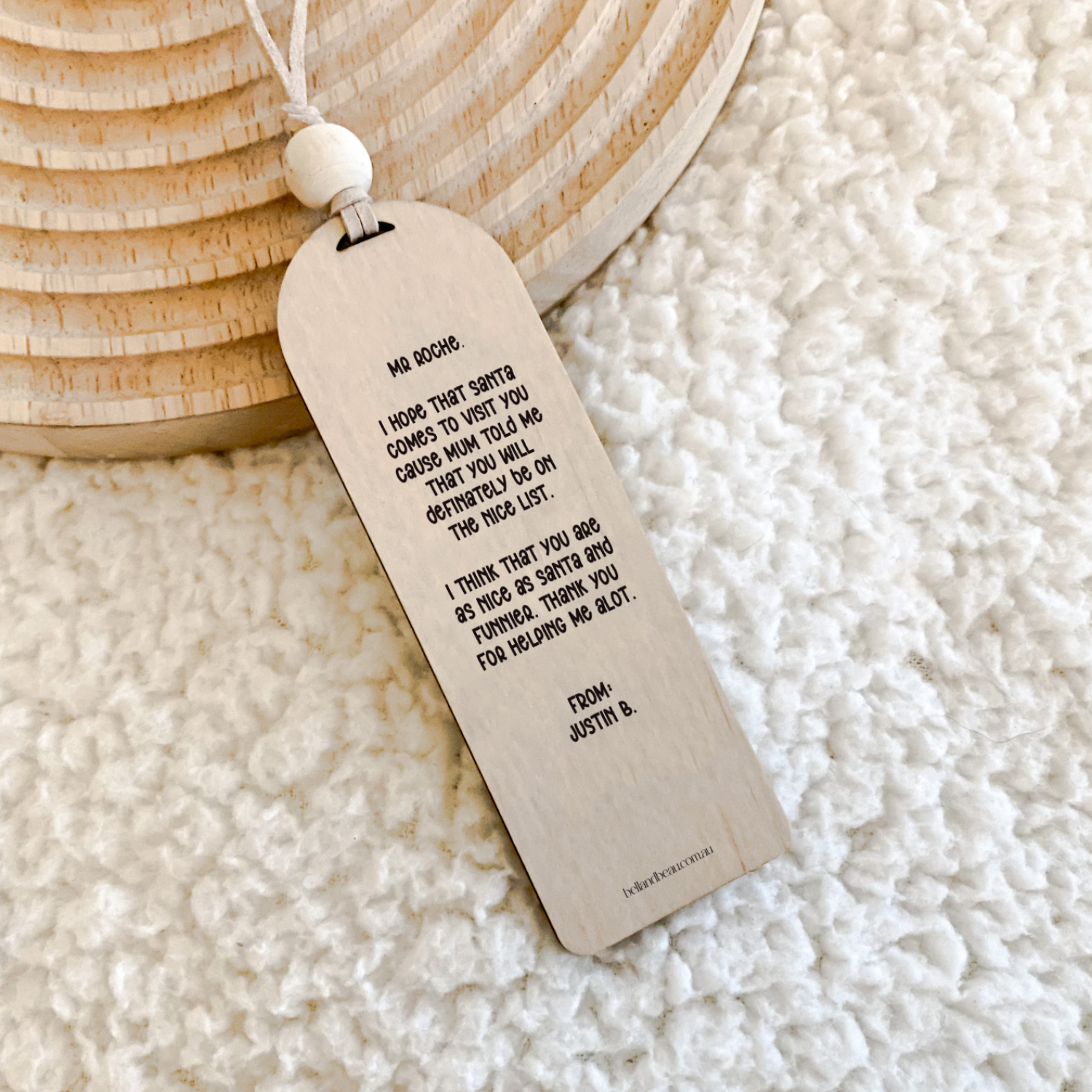 Close-up of a personalised wooden bookmark featuring bee illustrations and a thank you message for teachers.