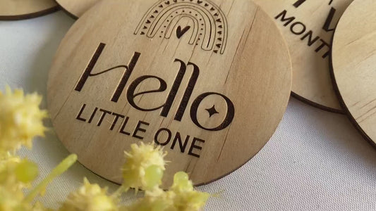 Beautiful rainbow milestone discs for babies, laser-engraved on sustainable FSC-certified wood. This 13-piece set includes “Hello Little One,” months one to eleven, and “One Year,” each designed for milestone photography and memory keeping. Ideal for newborn announcements, monthly photo updates, and gifts for expecting parents. A timeless keepsake, these wooden milestone discs capture your baby’s growth journey while adding charm to photos and nursery décor.