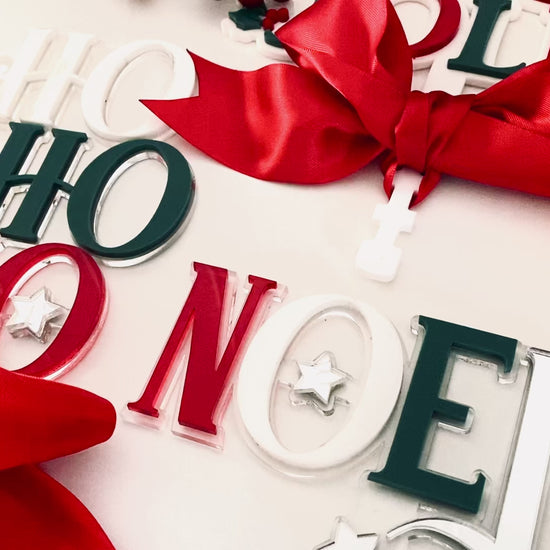Unique Christmas Tree Topper from Bell & Beau Design Co, featuring “Ho Ho Ho” stacked letters in white, green and red acrylic with a silver star and satin ribbon tie. Adds a modern festive touch to any holiday tree, perfect for Australian Christmas styling.