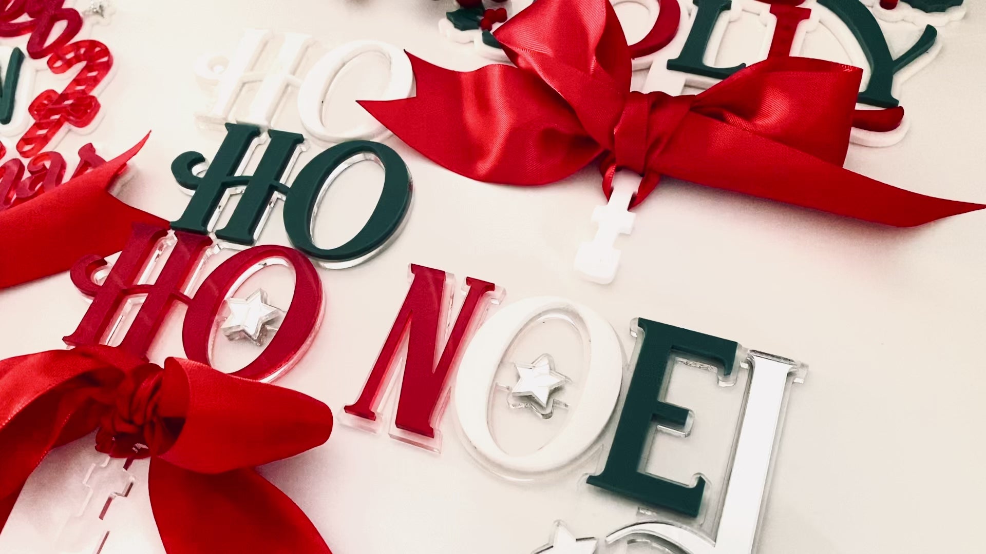 Unique Christmas Tree Topper from Bell & Beau Design Co, featuring “Ho Ho Ho” stacked letters in white, green and red acrylic with a silver star and satin ribbon tie. Adds a modern festive touch to any holiday tree, perfect for Australian Christmas styling.