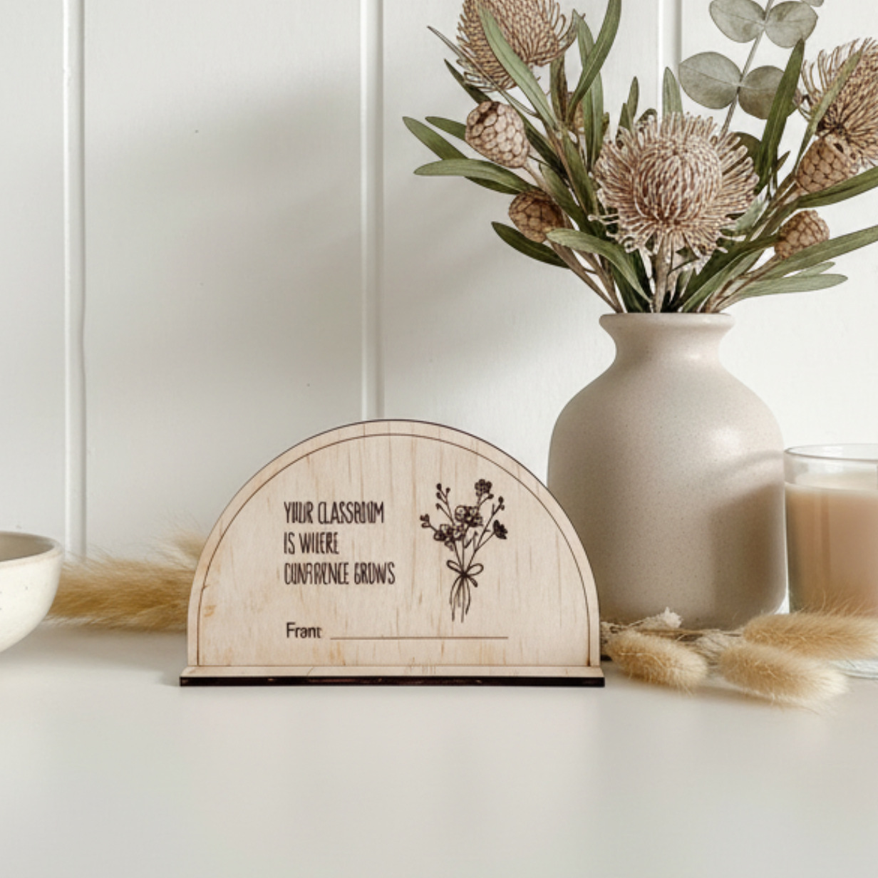 A personalised wooden desk sign for teachers with the quote "Your classroom is where confidence grows".